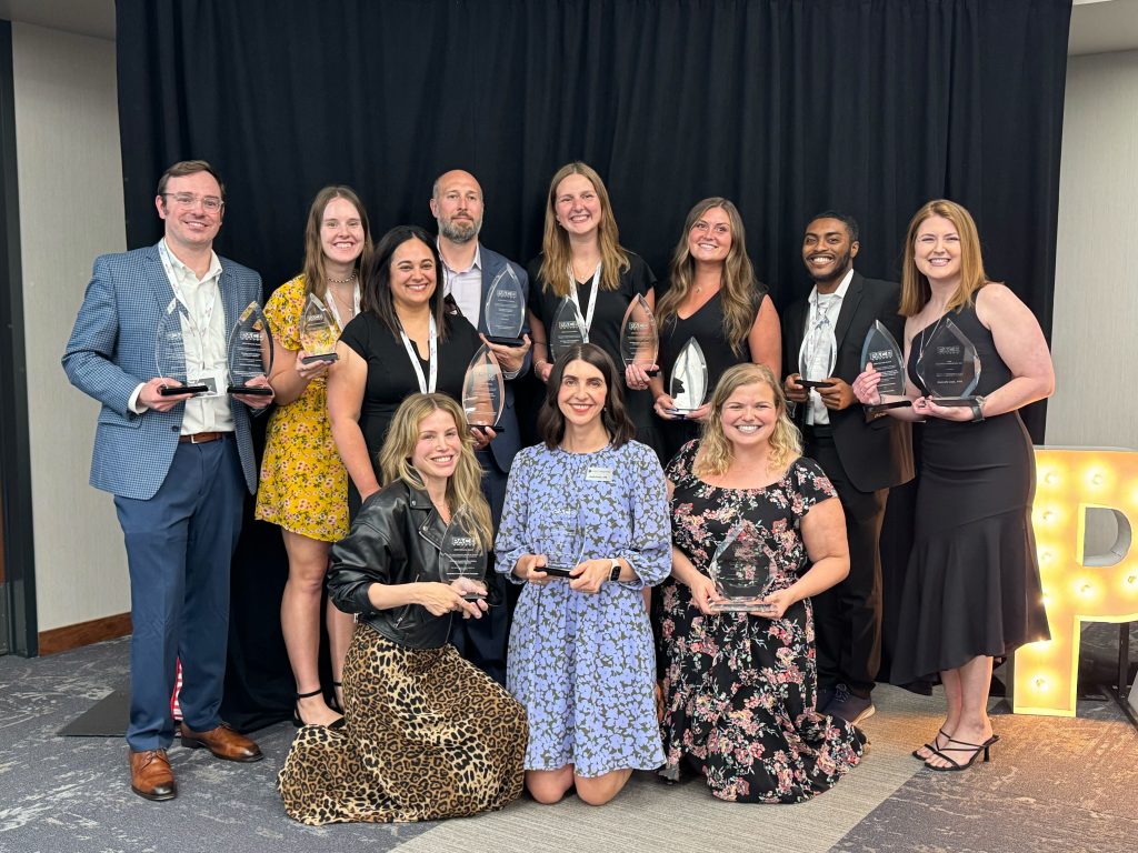 Group photo of Martin Waymire staff members holding awards at the PACE awards